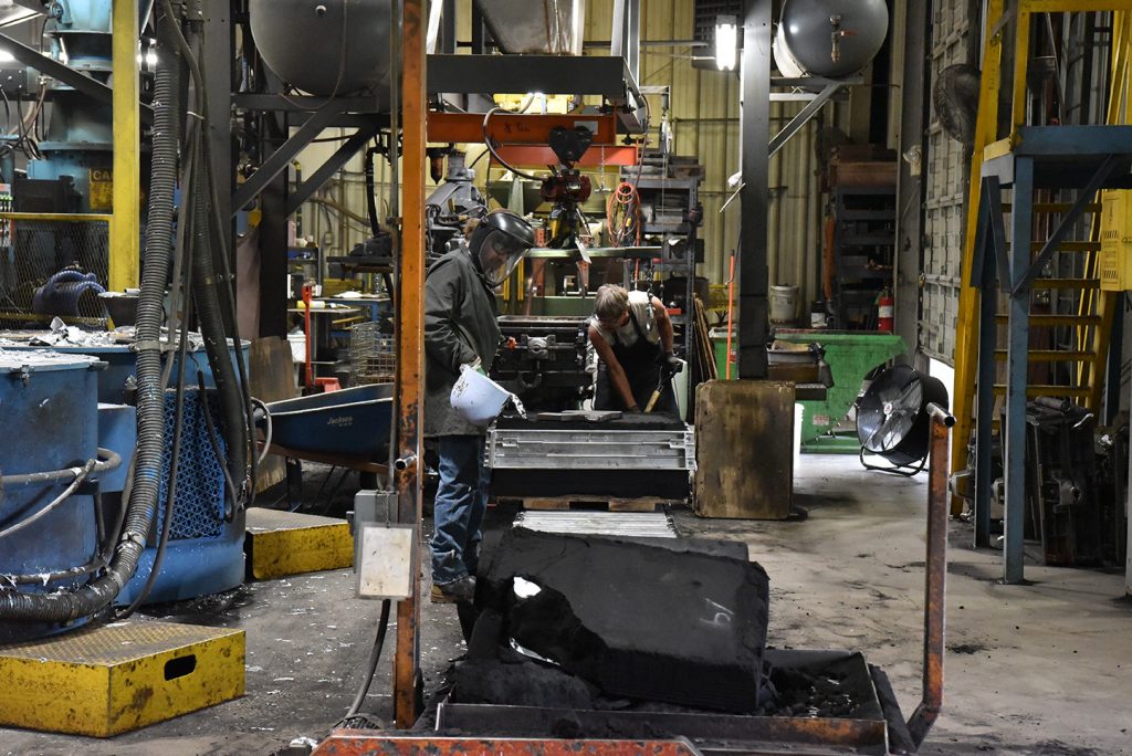 Superior technician pouring aluminum into a mold